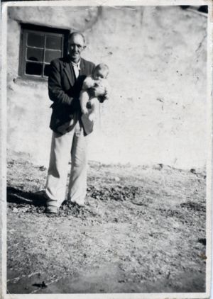 John McLaughlan holding an unknown baby