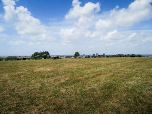 Field area before the cemetery with graves in the distance