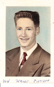 a young man with a flat-top haircut smiles at the camera